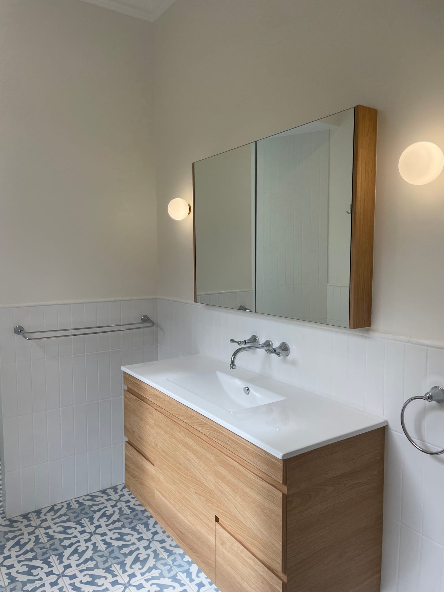 Bathroom with timber vanity and patterned floor tiles